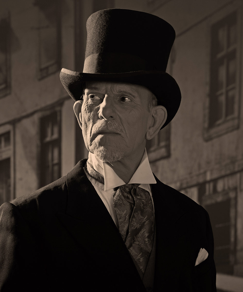 1900stylemanwearingblackhatandcoat.MedicinemaninDicke